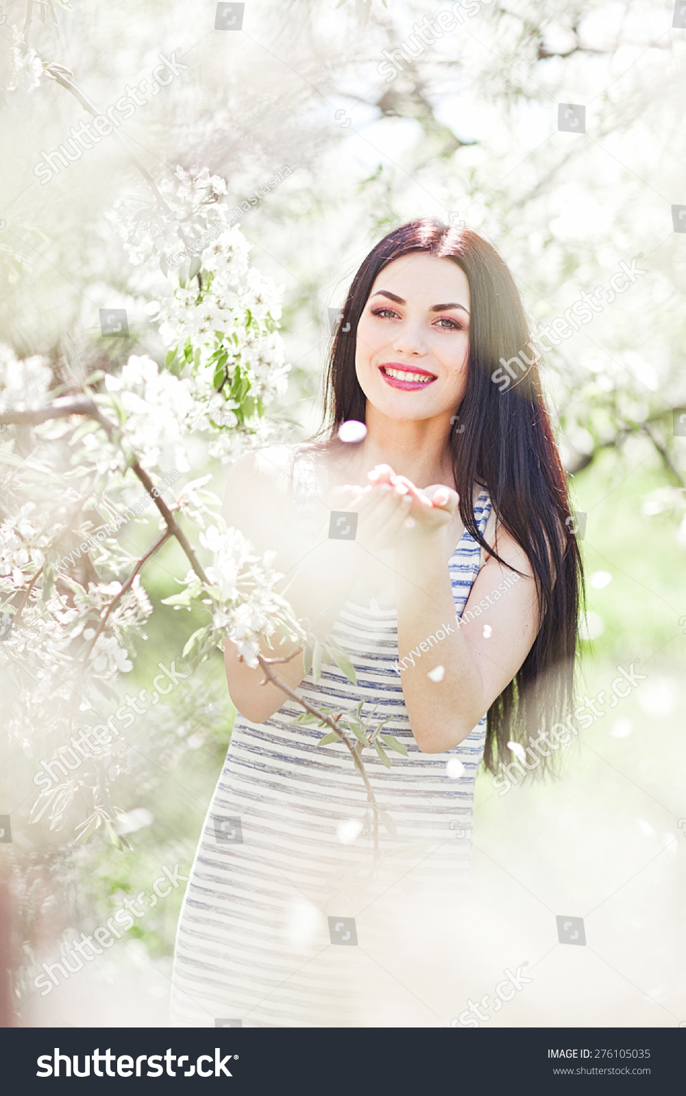portrait of young lovely woman in spring flowers #276105035