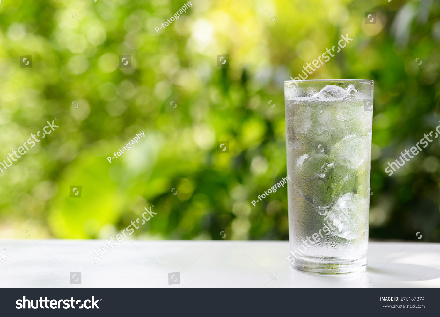 a glass of water with ice on nature background. #276187874