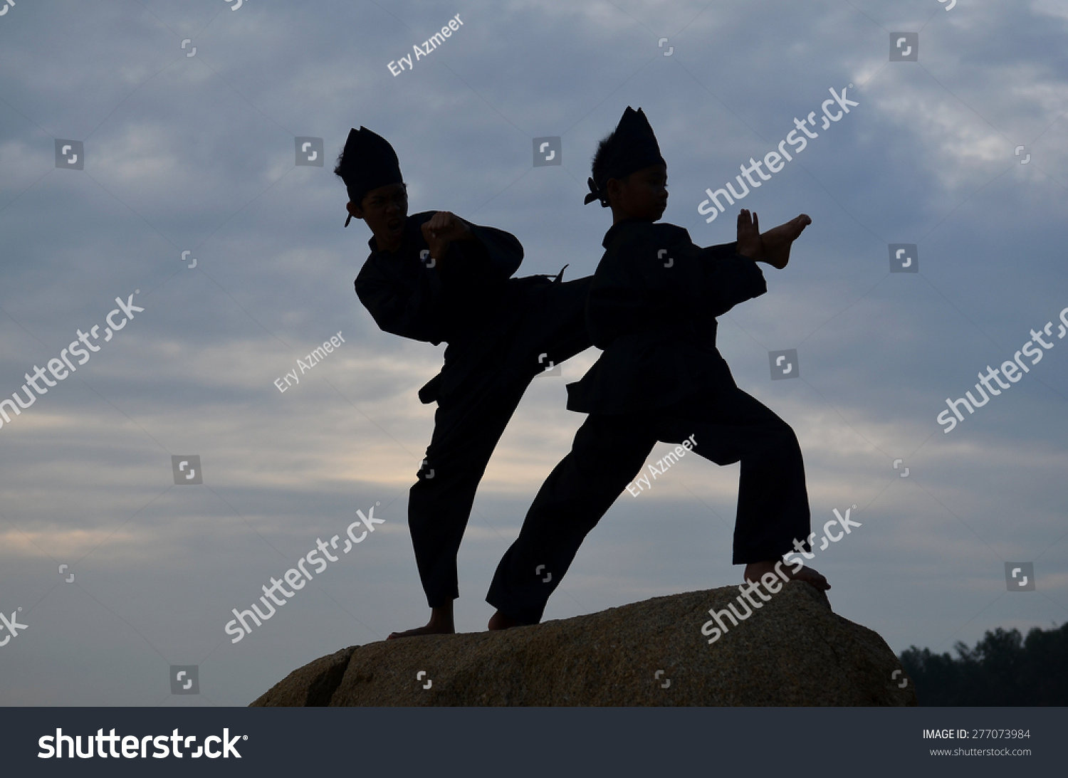  Silhouette of two young boys sparring a Stock Photo 