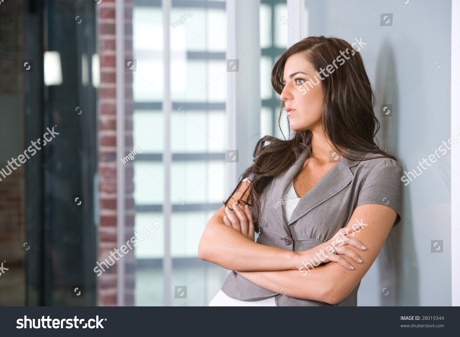Business woman arms crossed in a modern office #28019344