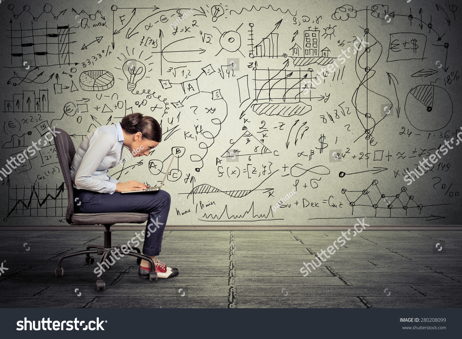 Young serious woman working on computer sitting on chair  #280208099