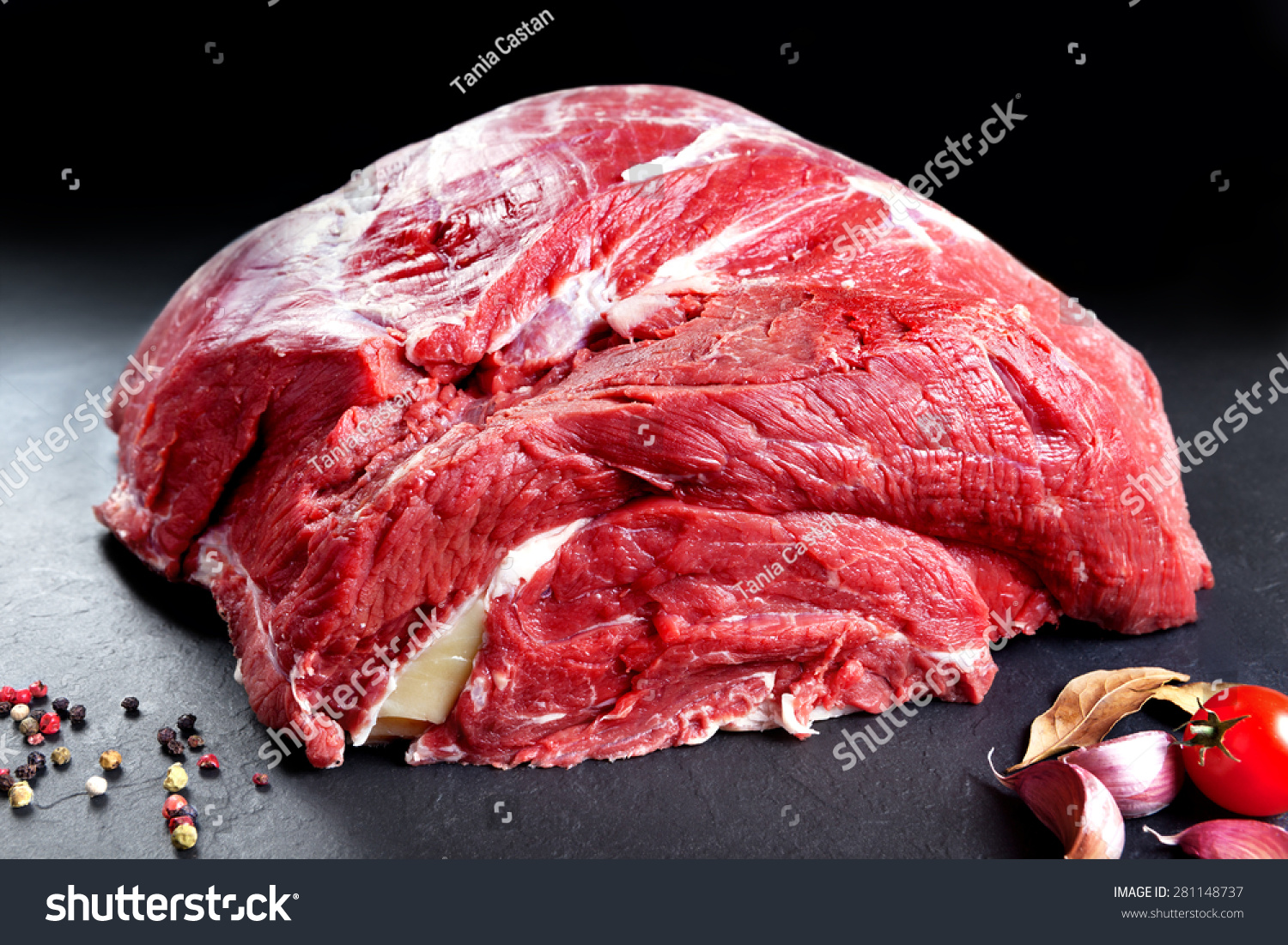 Fresh and raw meat. Whole piece of red meat ready to cook on the grill or BBQ .Background black blackboard #281148737