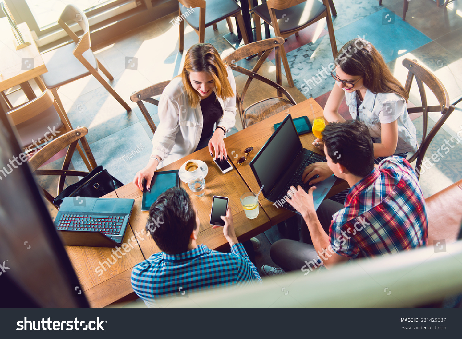 Group of young people sitting at a cafe, talking and enjoying, top view #281429387