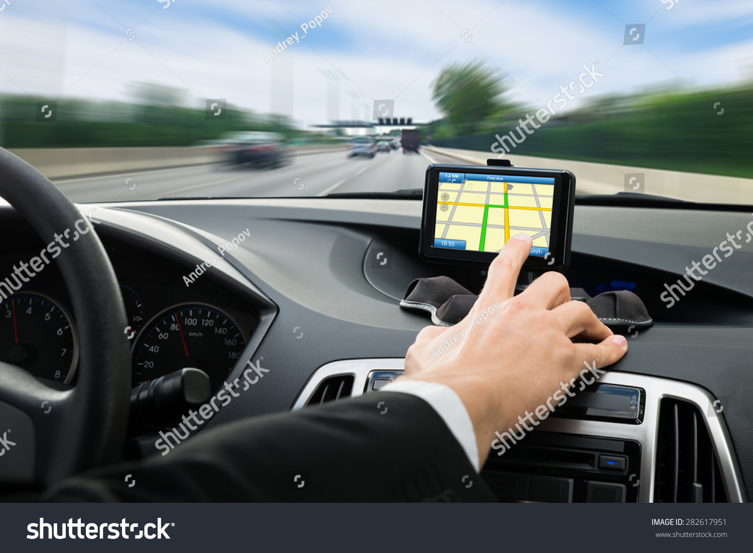 Close-up Of A Person's Hand Using Gps Navigation System In Car #282617951