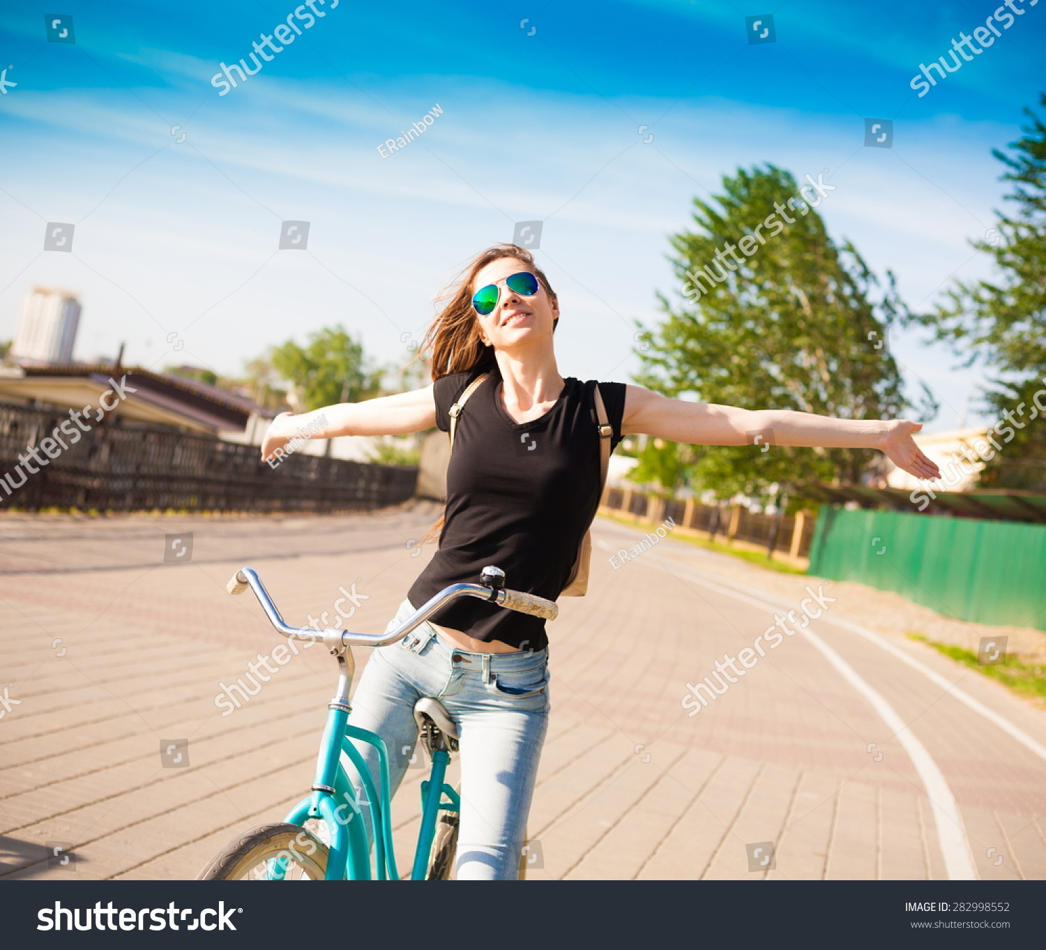 beautiful sensuality elegance haired hair woman happy fun cheerful smiling blue sunglasses black t-shirt jeans bicycle urban city portrait nature slim sport body hobby equipment riding bike cyclist  #282998552