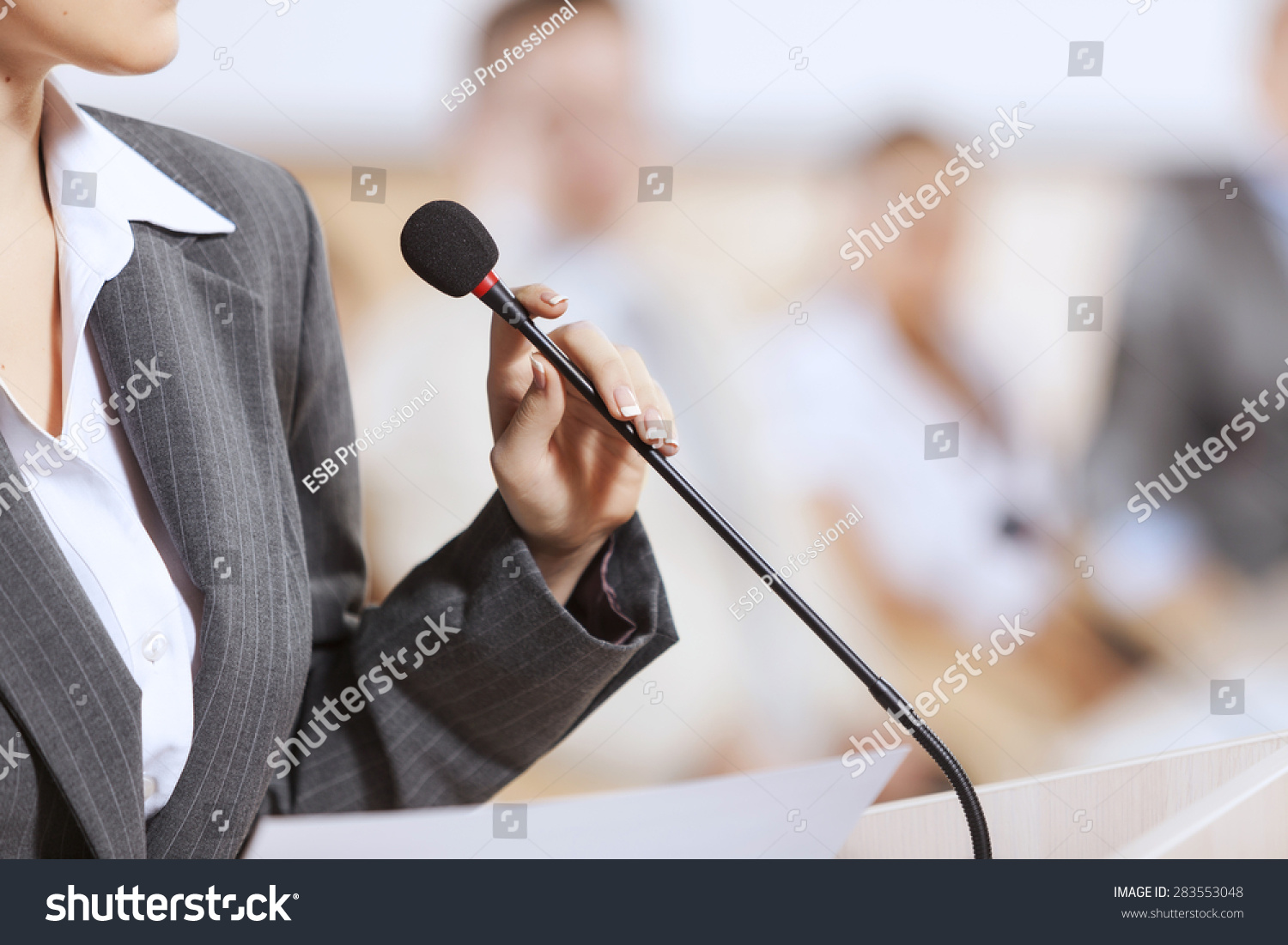 Businesswoman standing on stage and reporting for audience #283553048