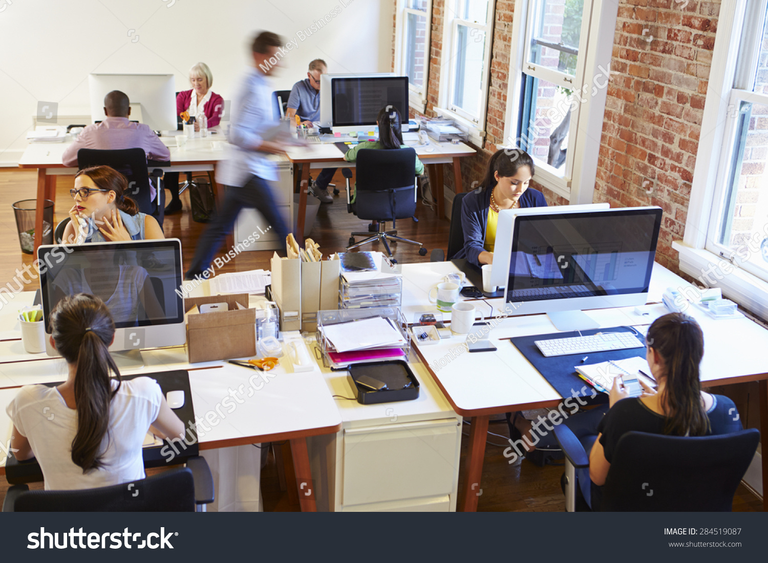 Wide Angle View Of Busy Design Office With Workers At Desks #284519087