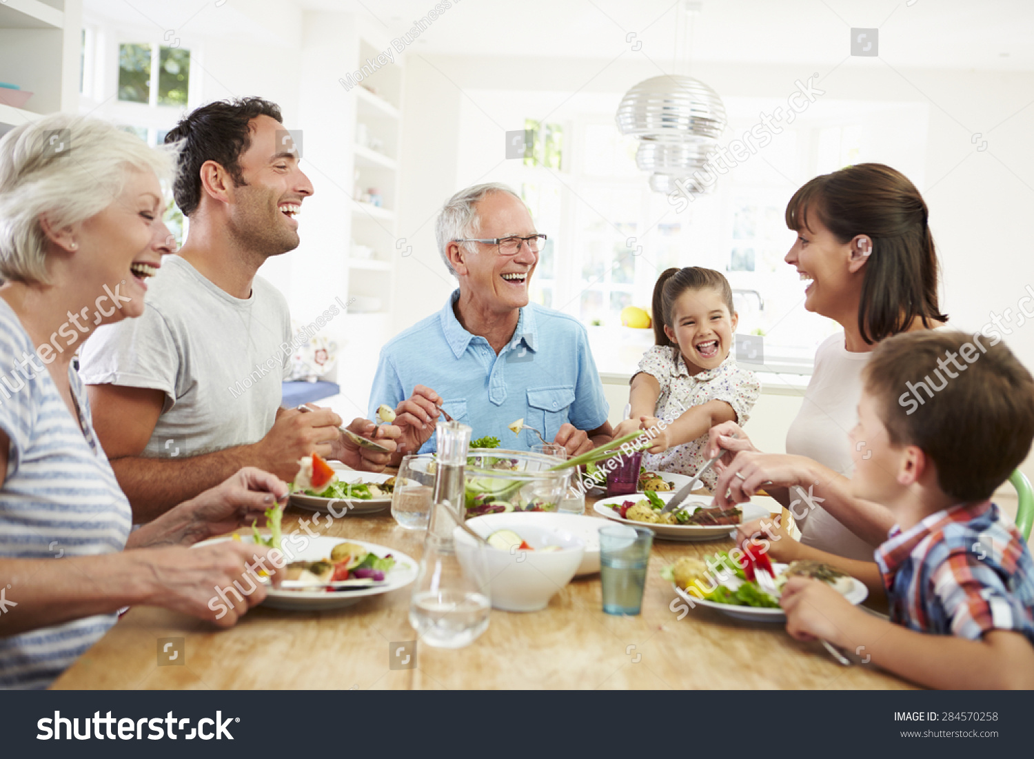 Multi Generation Family Eating Meal Around Kitchen Table #284570258