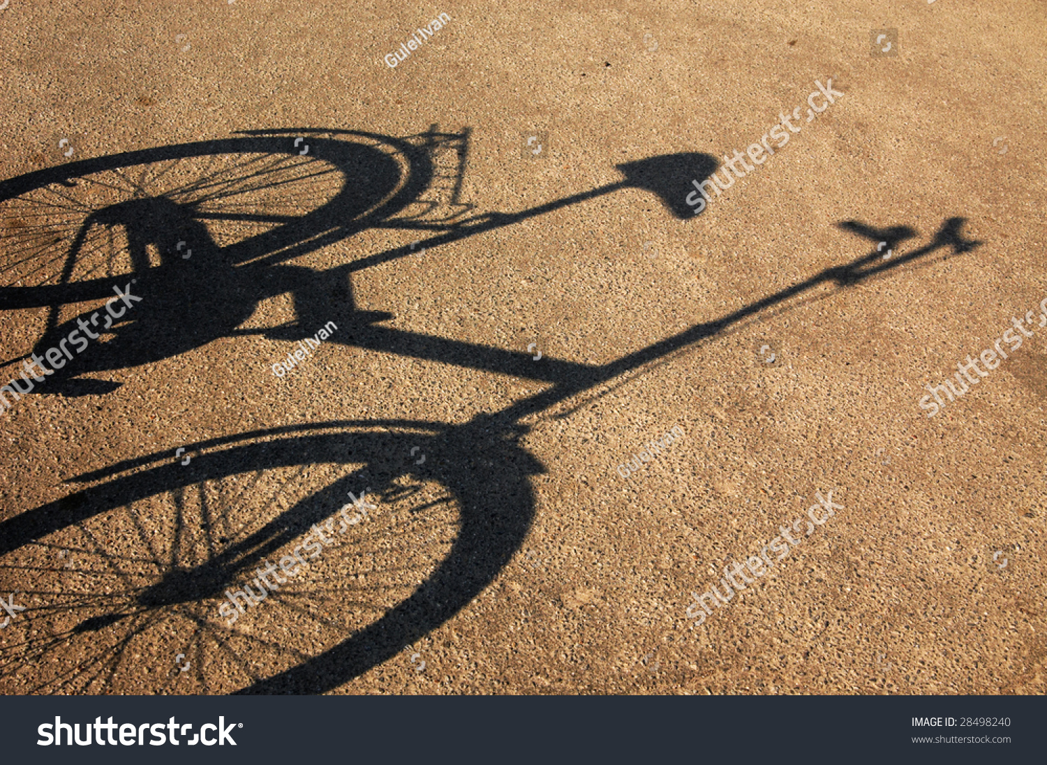 Shade of a bicycle on a cracked asphalt. #28498240