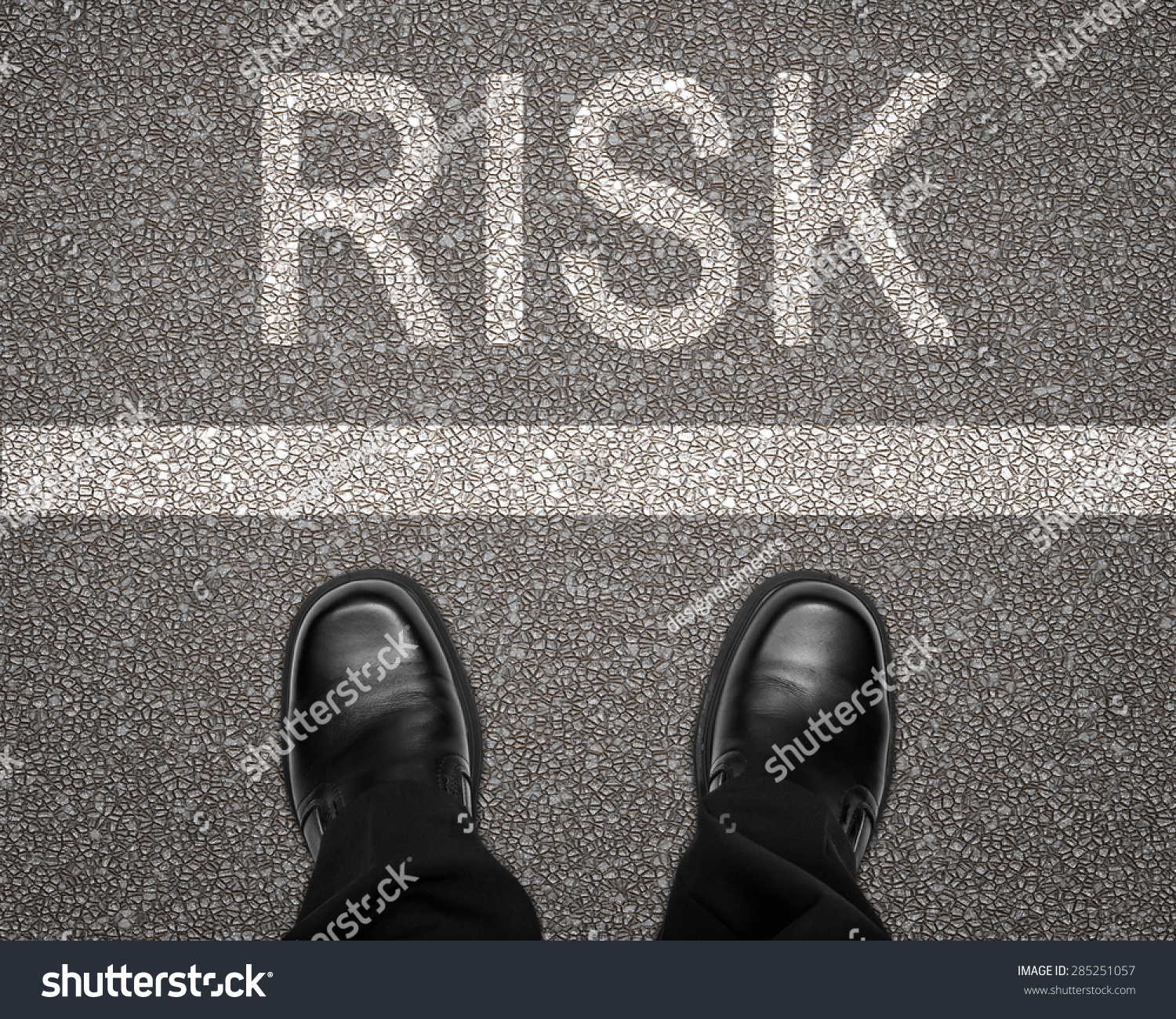 Take a risk concept with feet on road behind white line #285251057