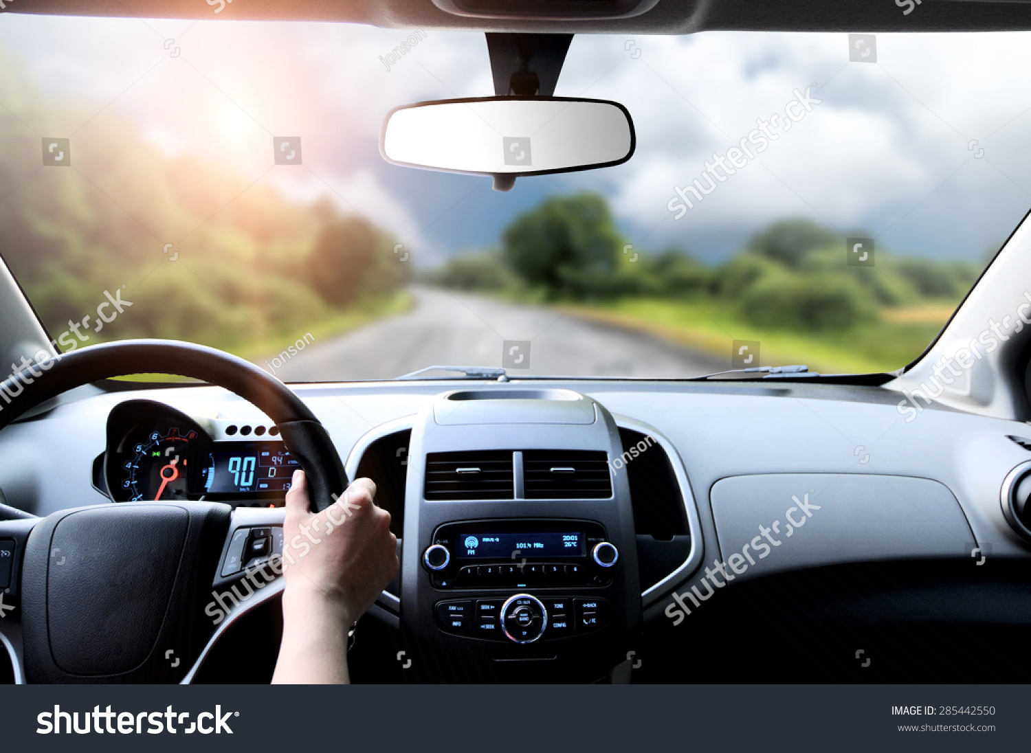 Driver's hands on the steering wheel inside of a car #285442550