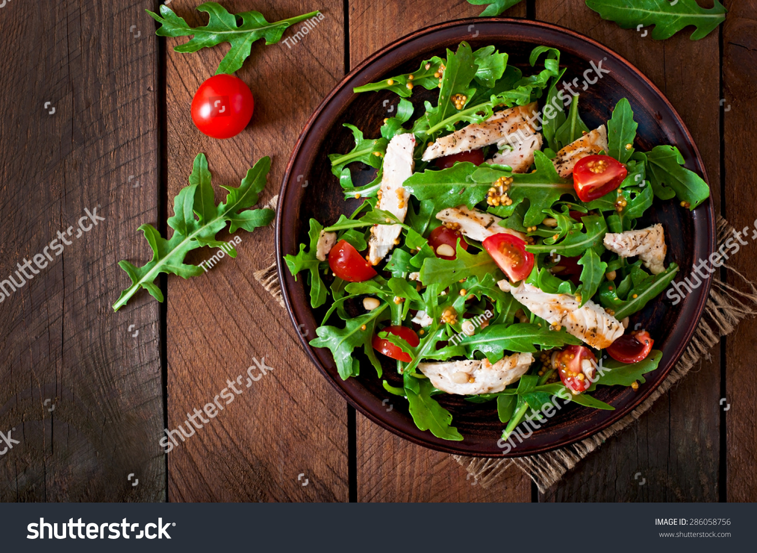 Fresh salad with chicken breast, arugula and tomato. Top view #286058756