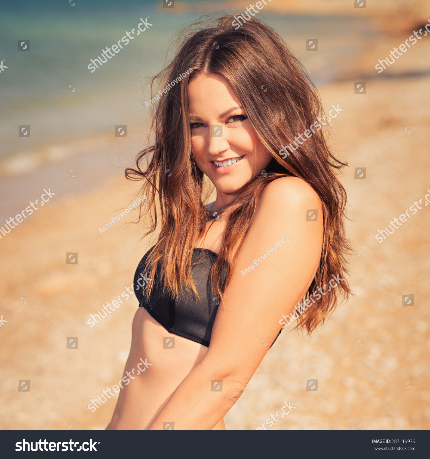 Fashion summer outdoor portrait of beautiful young woman. Hipster style. young pretty girl with long hair posing at beach. Photo with instagram style filters #287119976