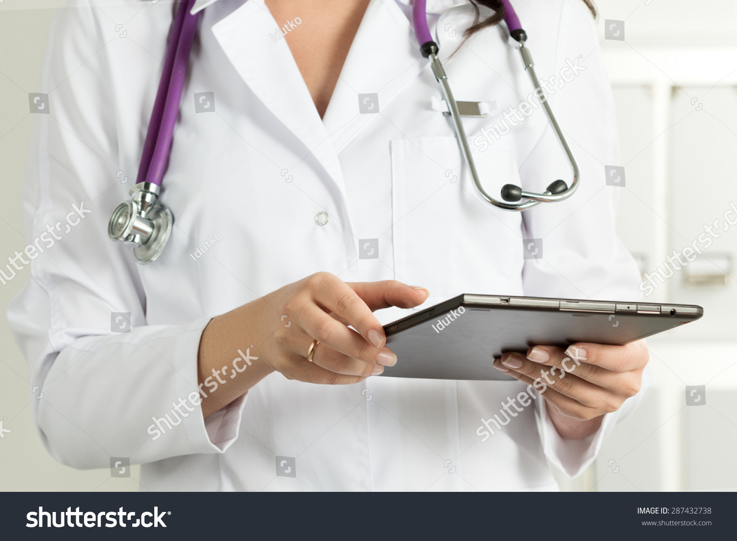 Female Doctor Holding Tablet PC. Doctor's hands close-up. Medical service and health care concept. #287432738