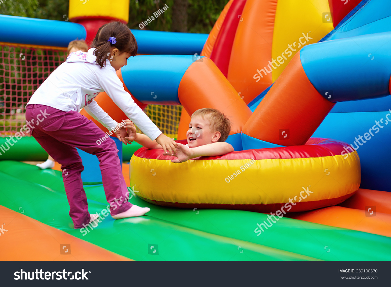 happy kids having fun on inflatable attraction playground #289100570