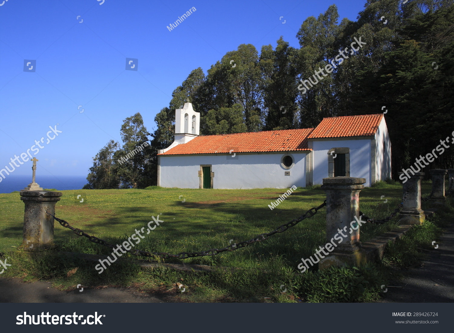 Hermitage of San Antonio de Corveiro, Cedeira, A Coruña, Galicia, Spain, cruceiro, views of the Atlantic Ocean, white church surrounded by green meadows and eucalyptus, place of Roman pilgrimages  #289426724