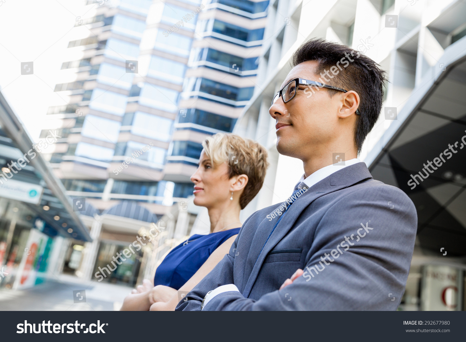Businessteam members standing next to each other in business district #292677980