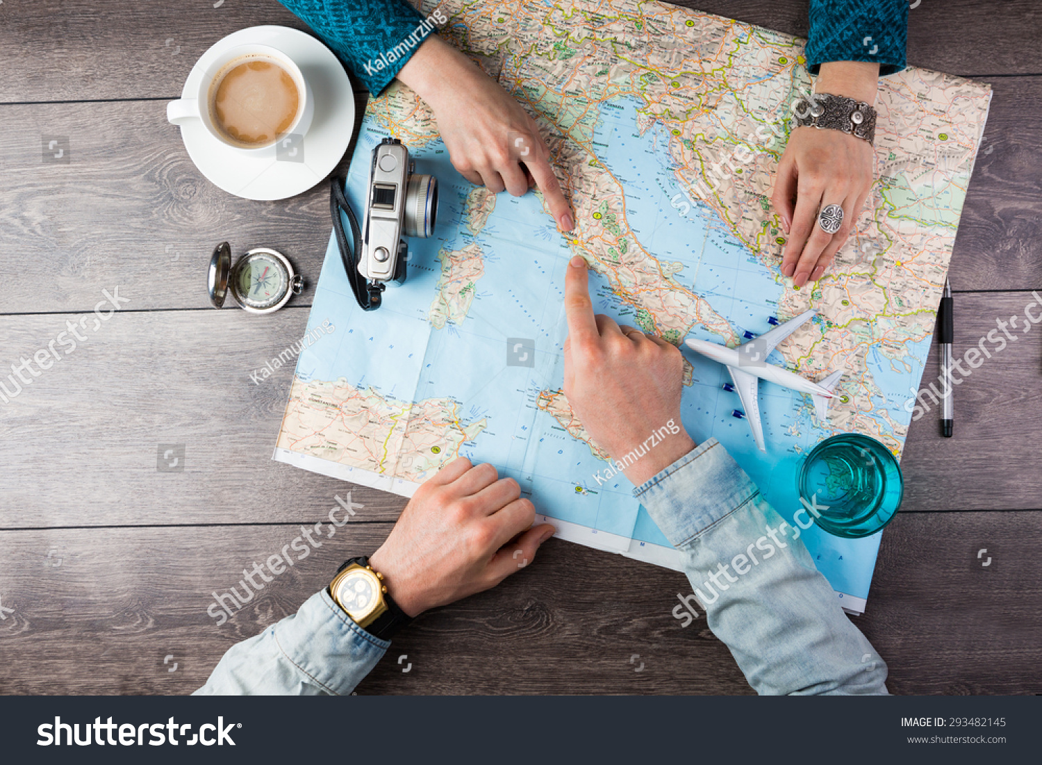 Young couple planning honeymoon vacation trip with map. Top view. Pointing to Europe Rome #293482145