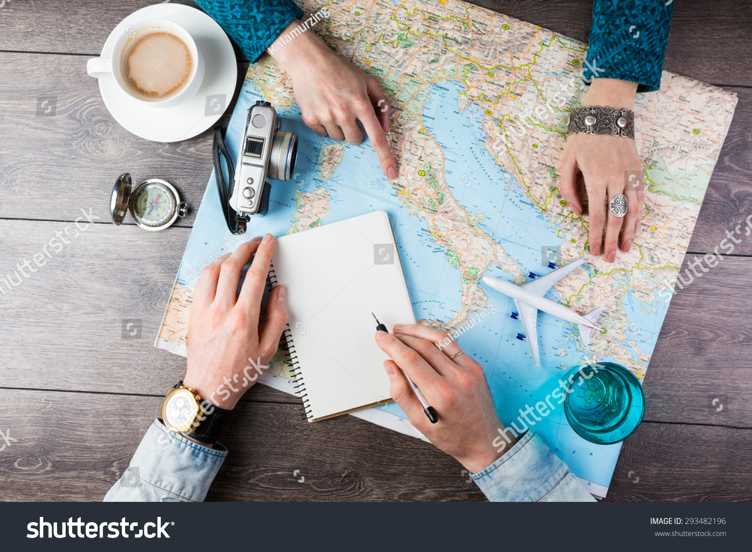 Two young people together planning trip to Europe. Top view. empty white space in notebook where you can place your text or advertisement.  Romantic travel #293482196