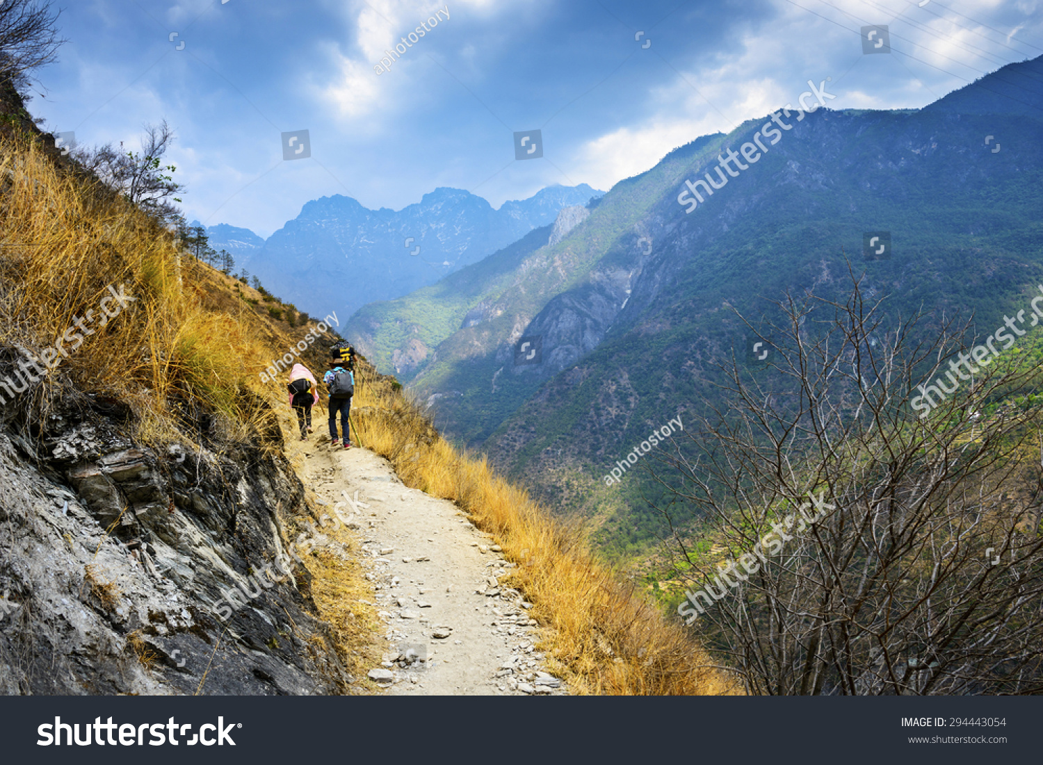 Hiking path (the high road) of Tiger Leaping Gorge. Travelers hiking in the mountains. Located 60 kilometres north of Lijiang City, Yunnan Province, China. #294443054