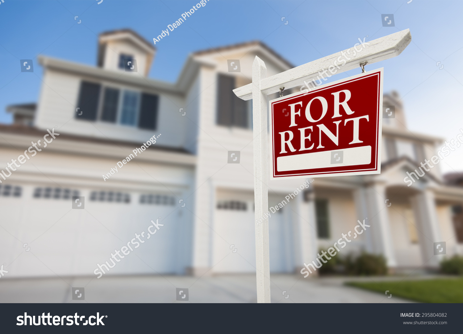 Red For Rent Real Estate Sign in Front of Beautiful House. #295804082