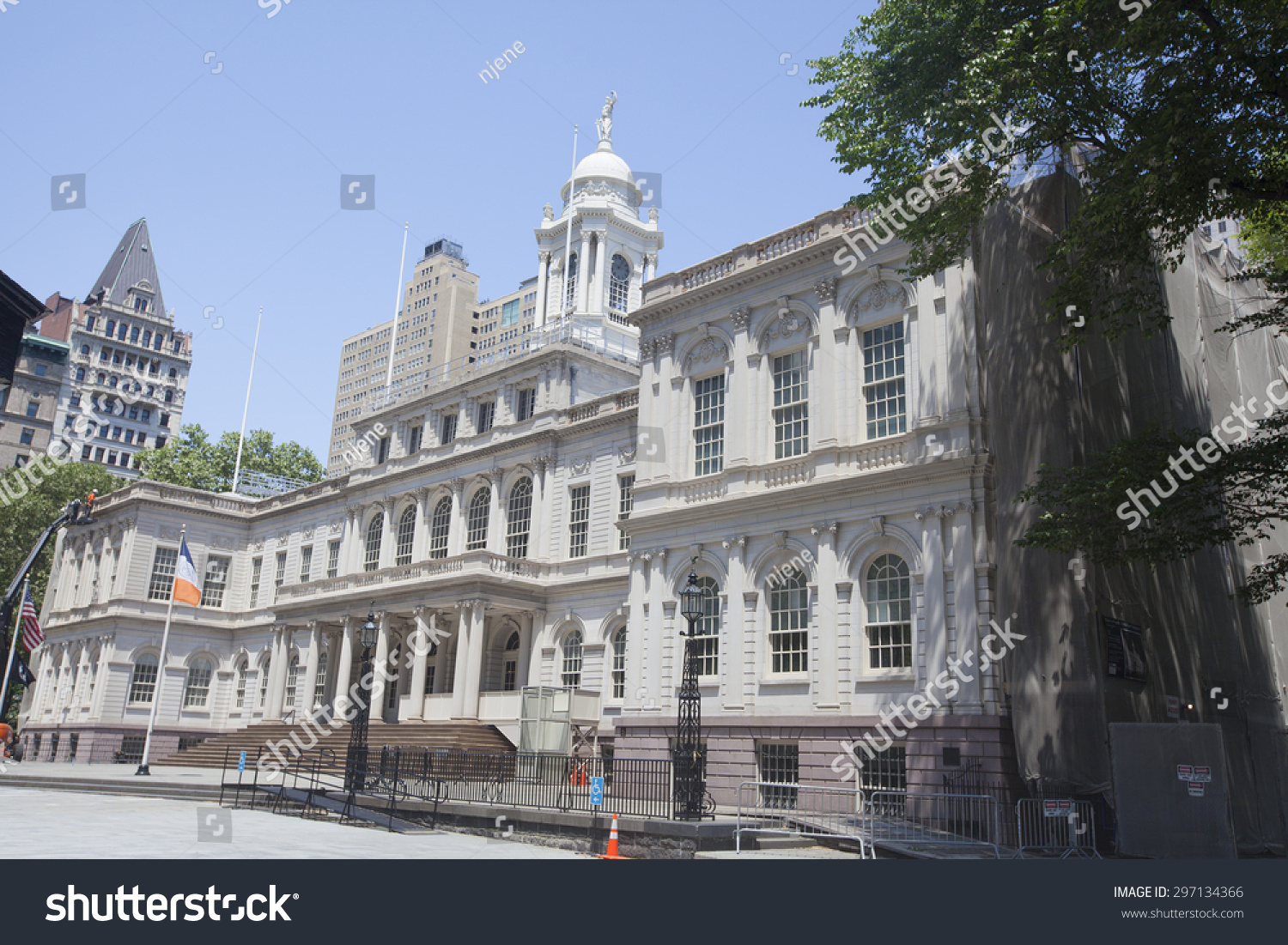NEW YORK - May 30, 2015: New York City Hall is located at the center of City Hall Park in the Civic Center area of Lower Manhattan, New York City, between Broadway, Park Row, and Chambers Street. #297134366