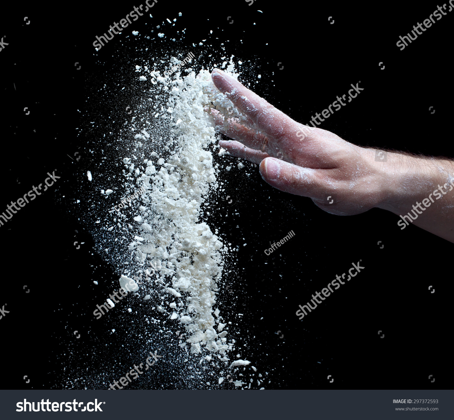 
the man's hand and a handful of flour isolated on a black background #297372593