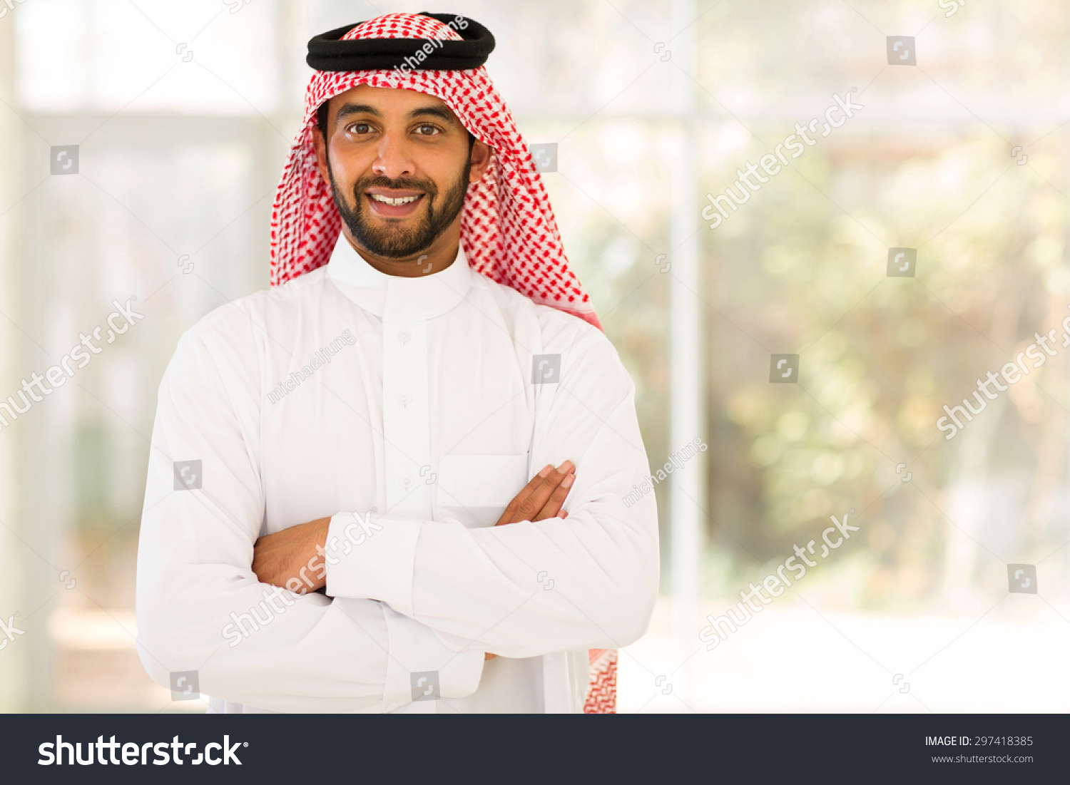 smiling arabian man with arms crossed #297418385