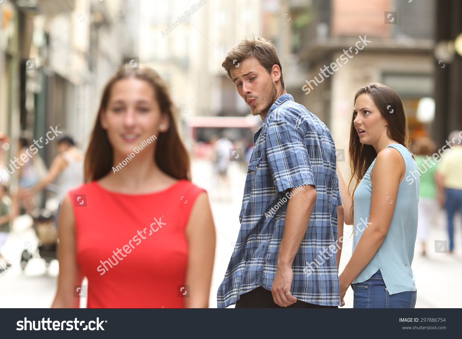 Disloyal man walking with his girlfriend and looking amazed at another seductive girl #297886754