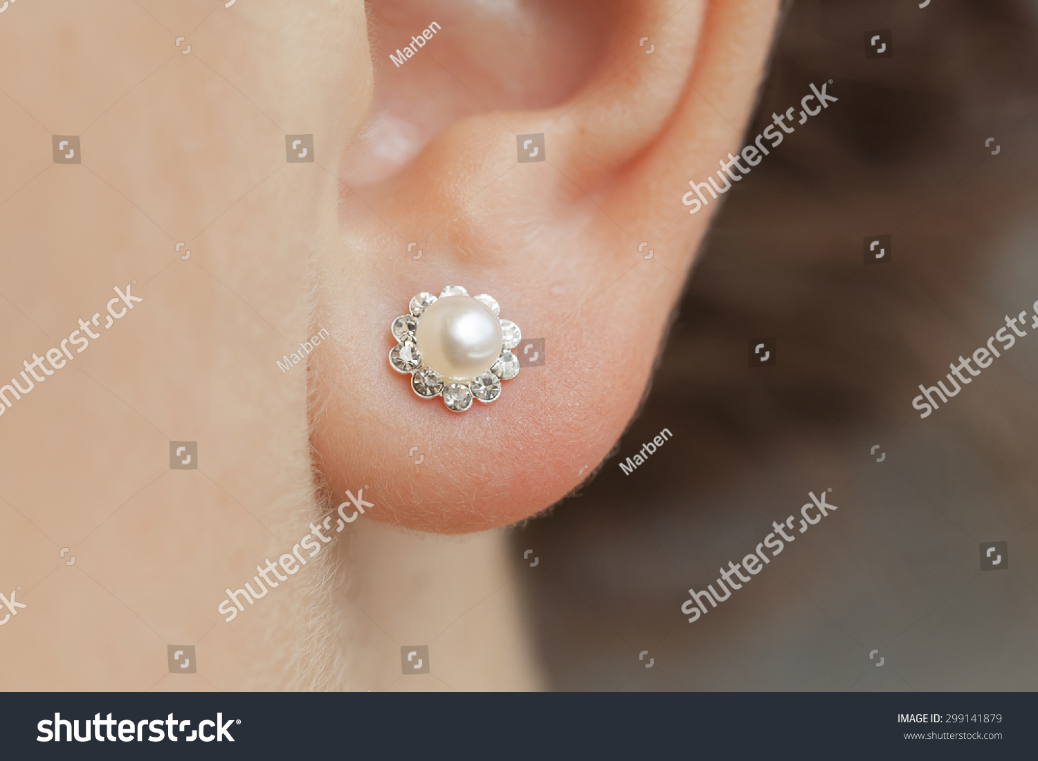woman's ear with an earring #299141879