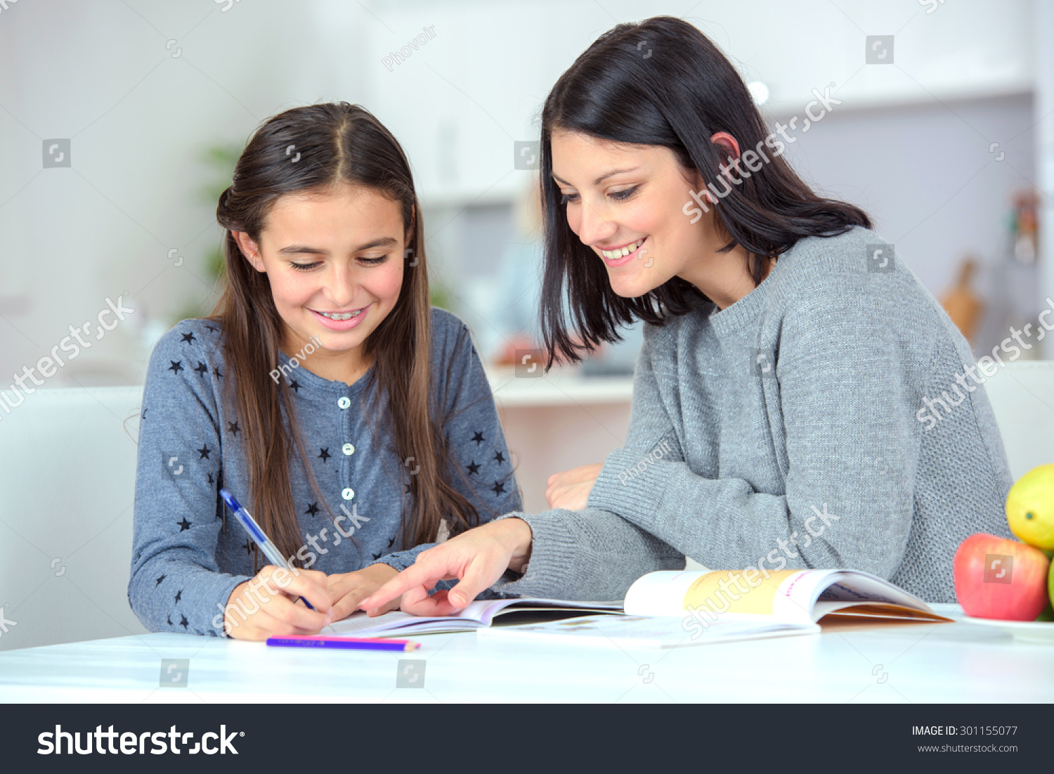 Mom helping her daughter do her homework #301155077