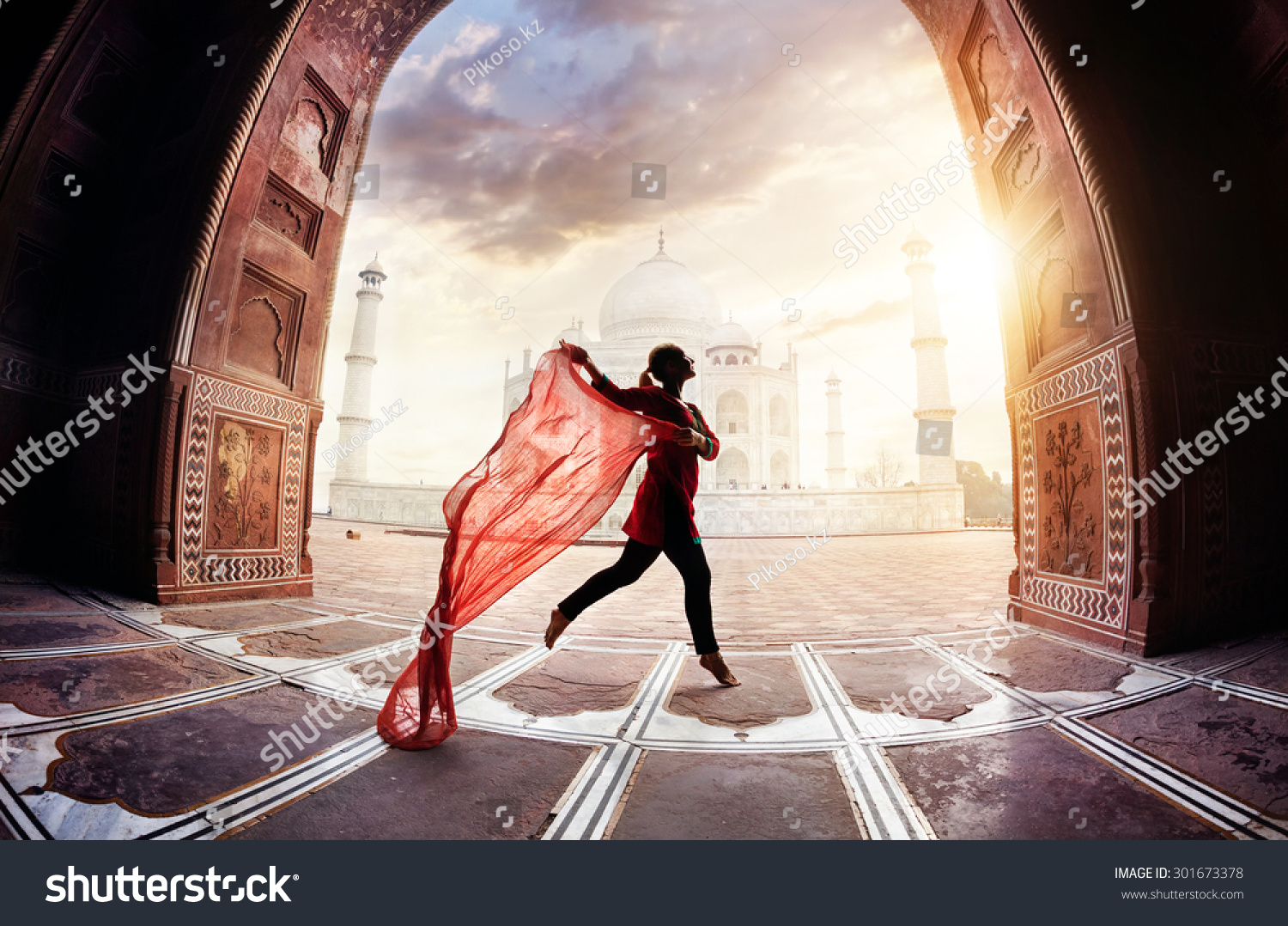 Woman with red scarf dancing near Taj Mahal in Agra, Uttar Pradesh, India #301673378