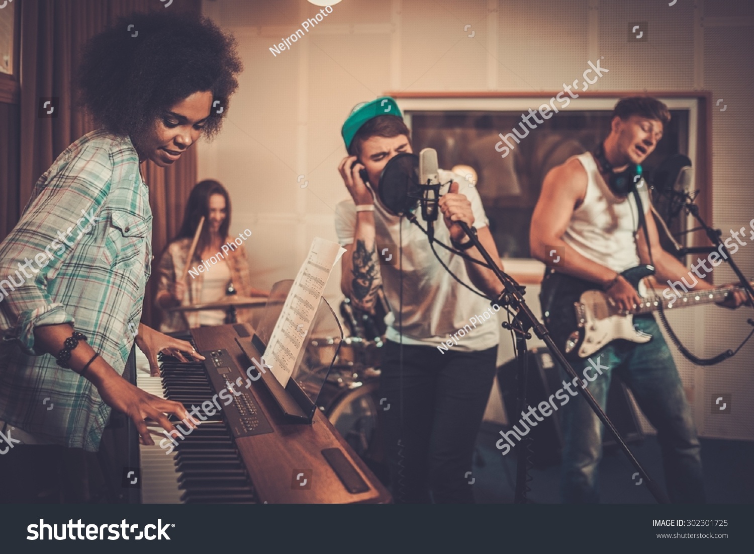 Multiracial music band performing in a recording studio  #302301725
