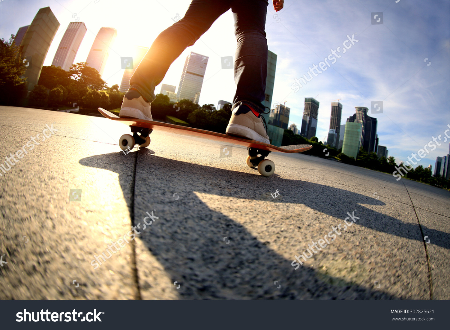 skateboarder skateboarding at sunrise city  #302825621
