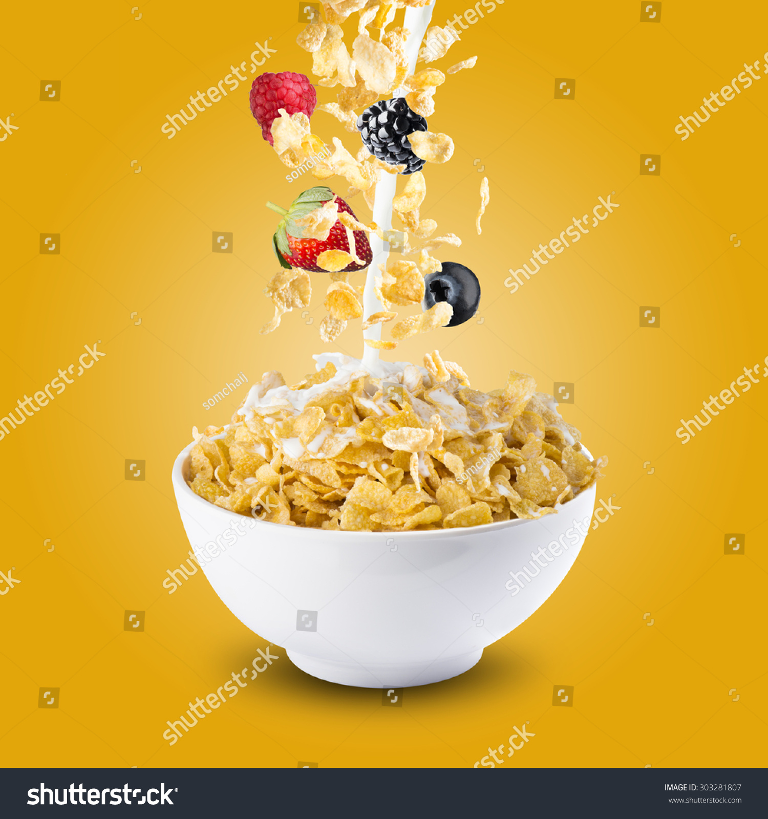 Various Berries Falling Into Bowl of Cereal With Milk Splash #303281807