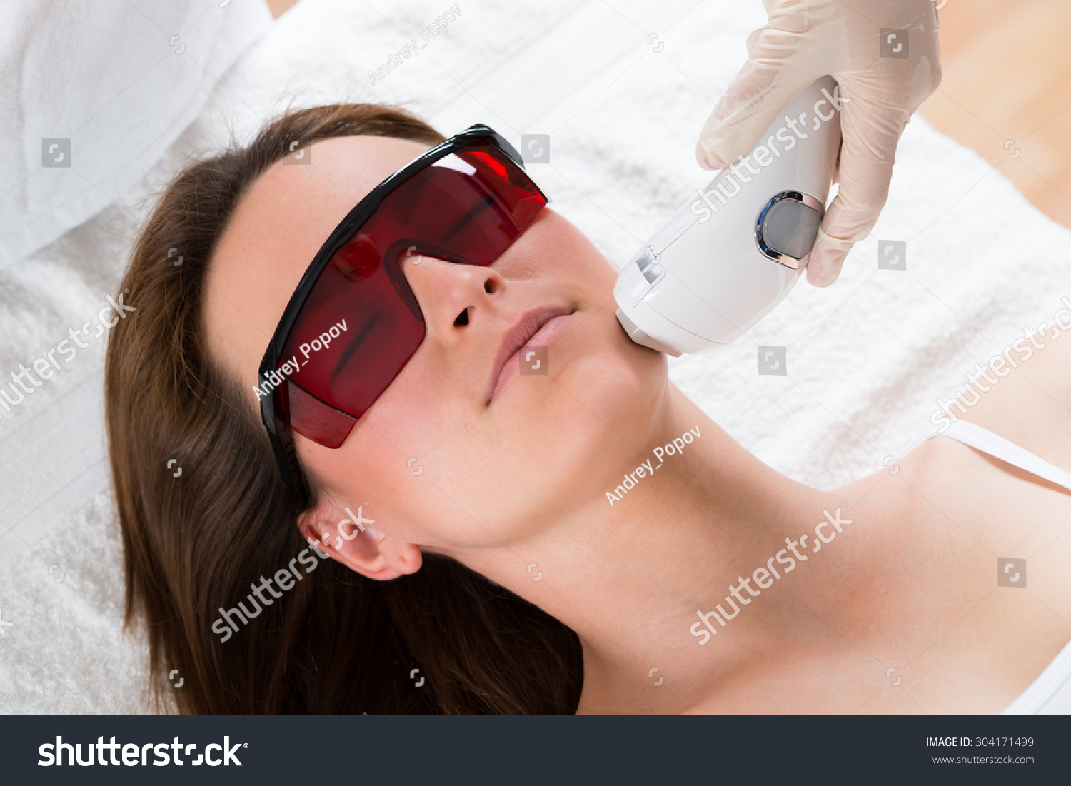 Young Woman Receiving Epilation Laser Treatment On Face At Beauty Center #304171499