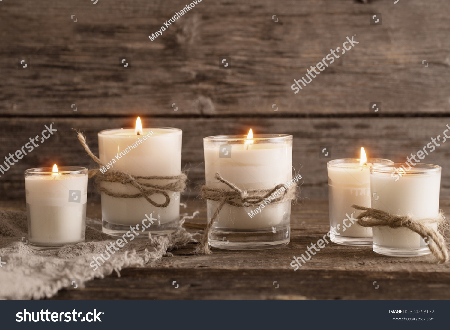 scented candles on old wooden background #304268132