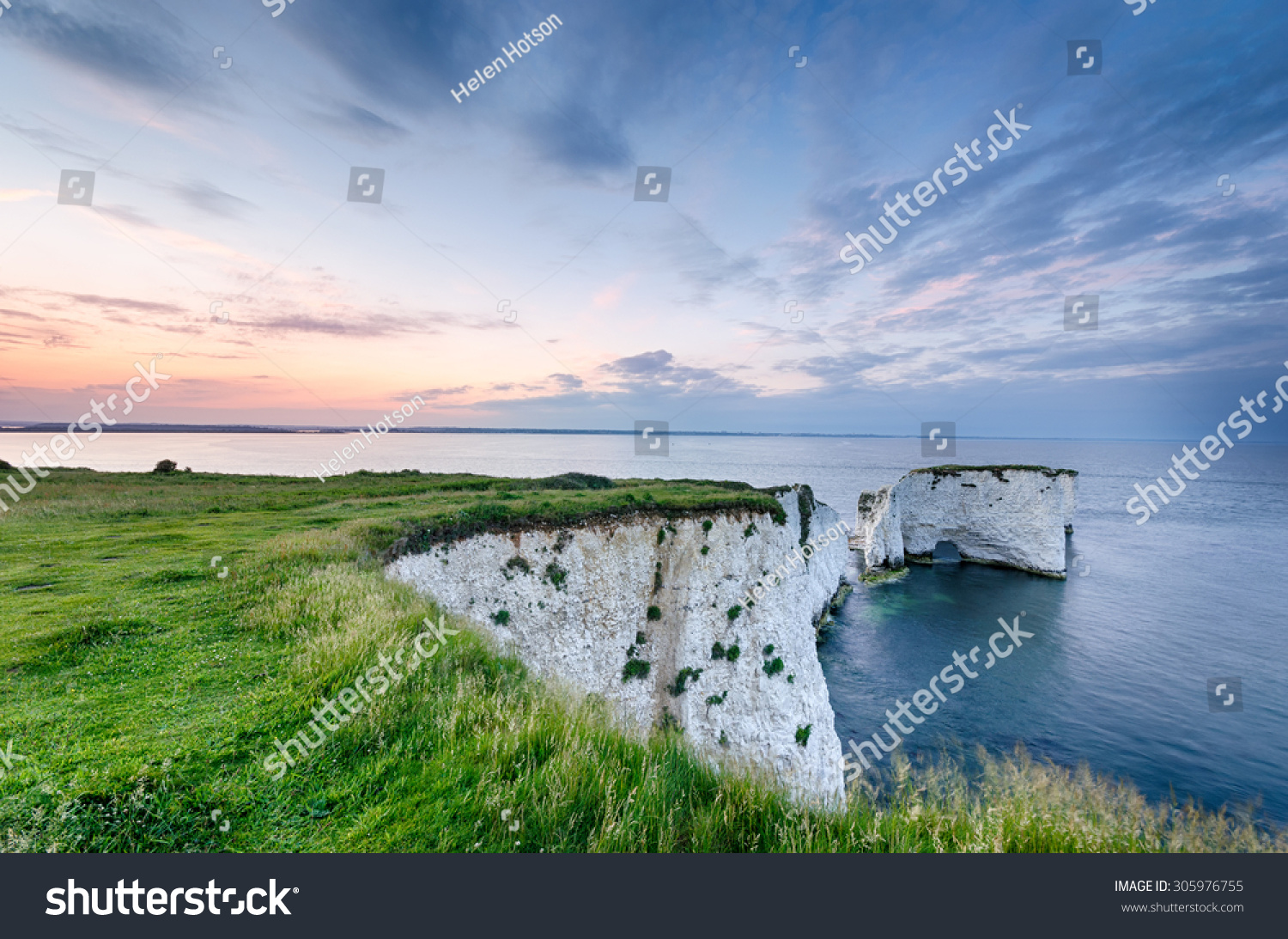 Sunset over Old Harry Rocks near Swanage and the start of the Jurassic Coast in Dorset #305976755