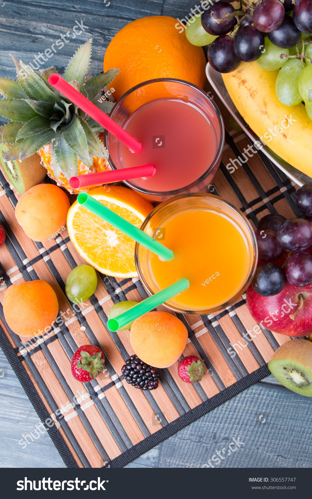 Breakfast concept with orange and strawberry juice, coffee, fruits on wooden table #306557747