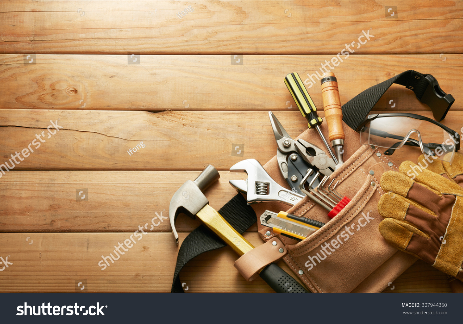 tools in tool belt on wood planks with copy space #307944350