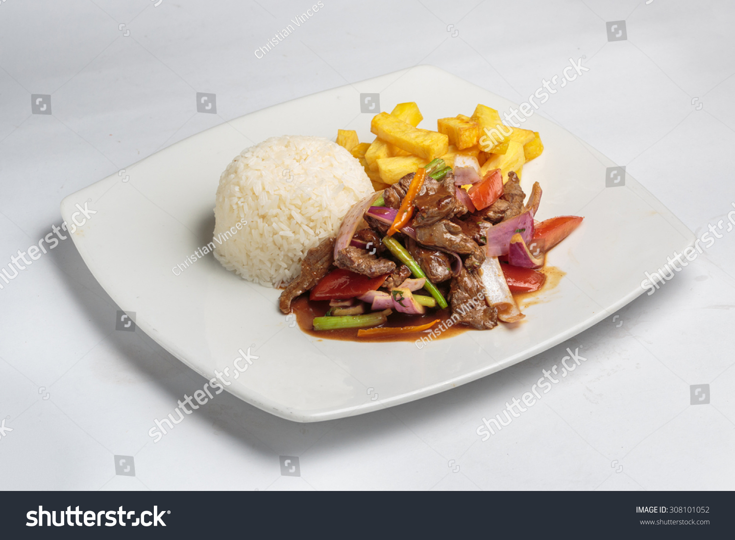 Peruvian food "lomo saltado":A salted beef with tomatoes, onion, fried potatoes and rice. #308101052