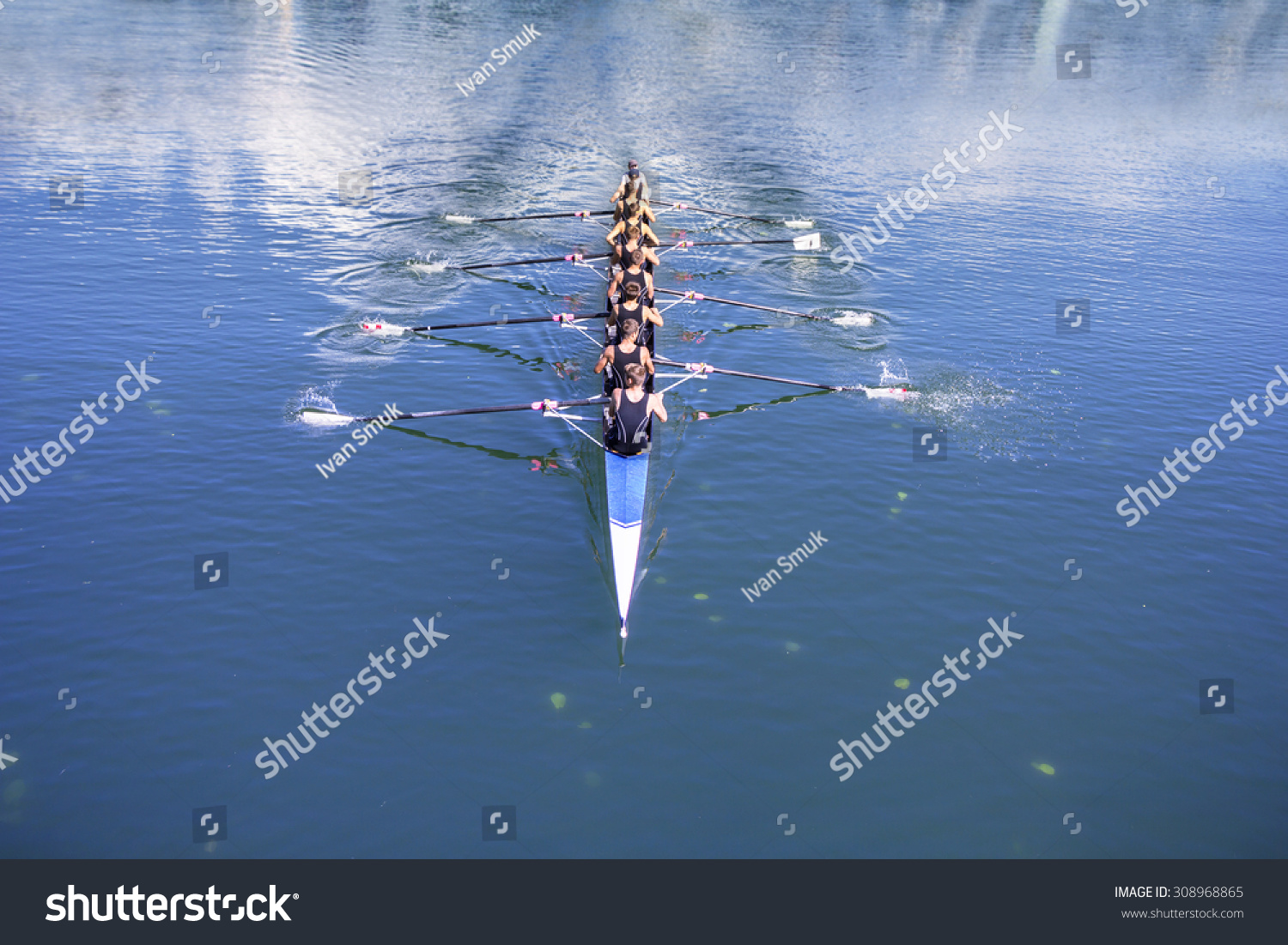 Rowers in eight-oar rowing boats on the tranquil lake #308968865