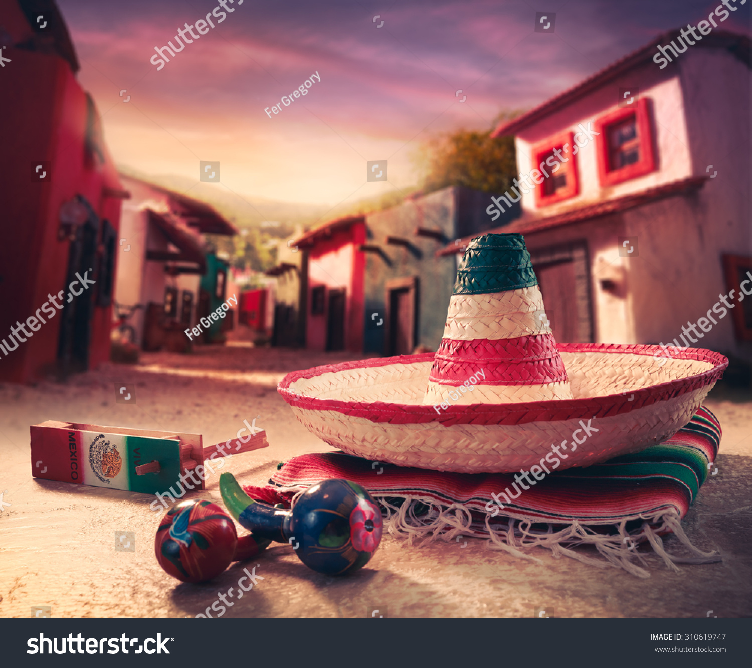 Mexican fiesta background with a hat "sombrero" and "maracas" in a mexican town #310619747