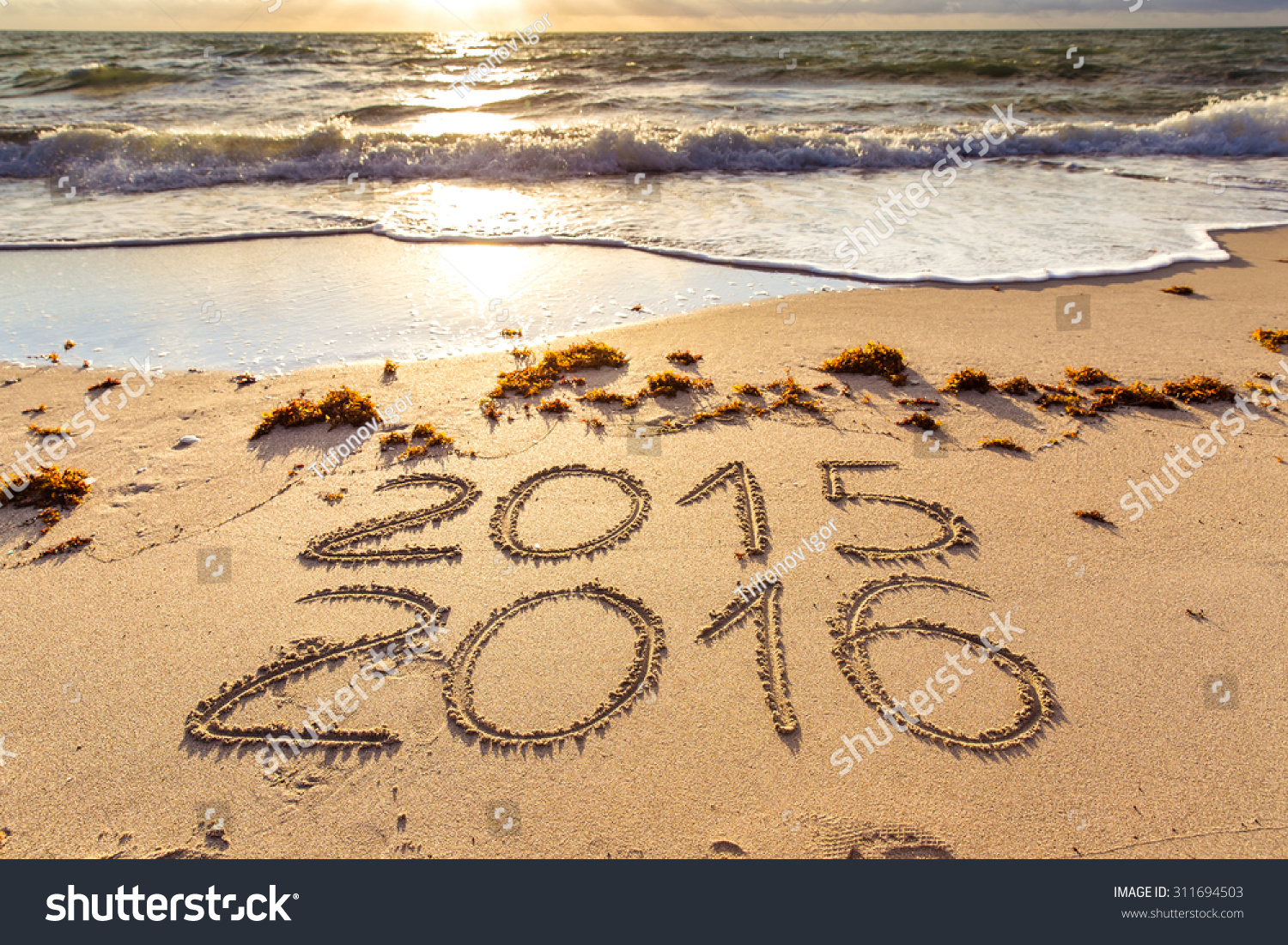 New Year 2016 is coming concept. 2015 and 2016 signs on a beach sand #311694503