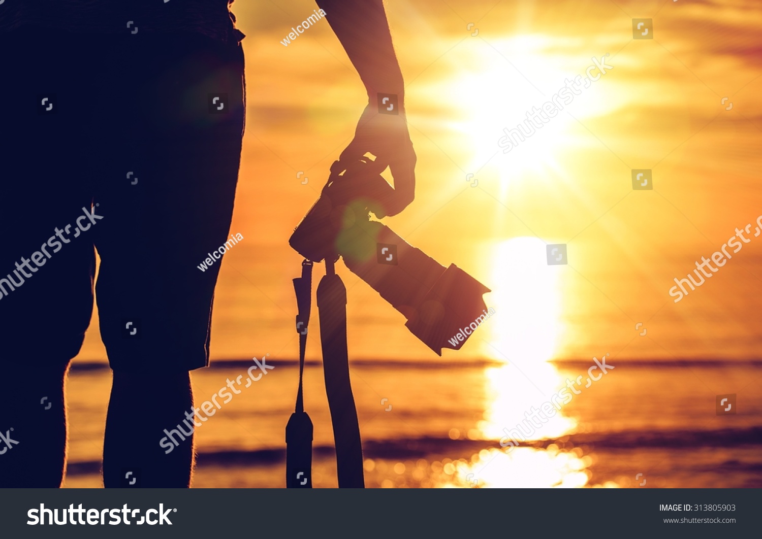 Sunset Photography. Photographer Ready to Take Sunset Pictures on the Beach. Professional Travel Photography Works. #313805903