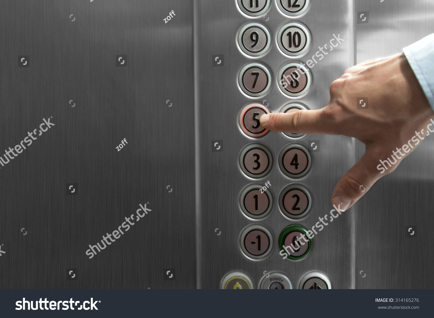 Forefinger pressing the fifth floor button in the elevator #314165276