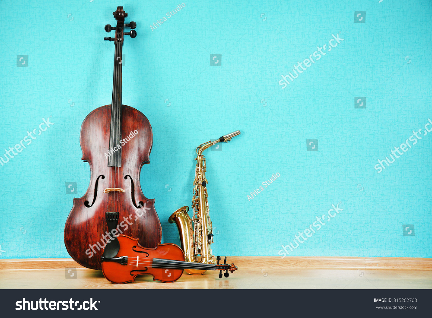 Musical instruments on turquoise wallpaper background #315202700