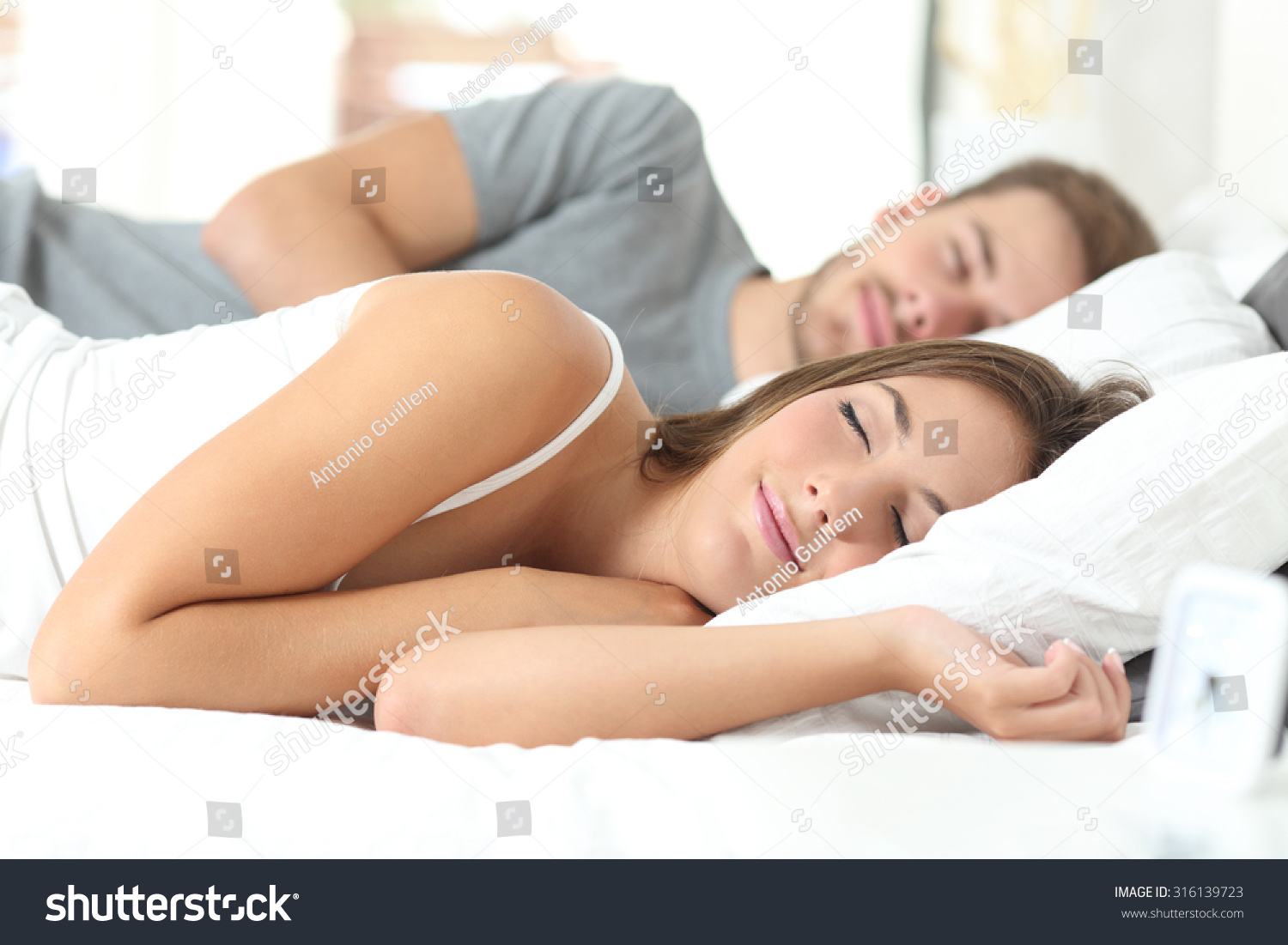 Happy couple sleeping in a comfortable bed at home #316139723