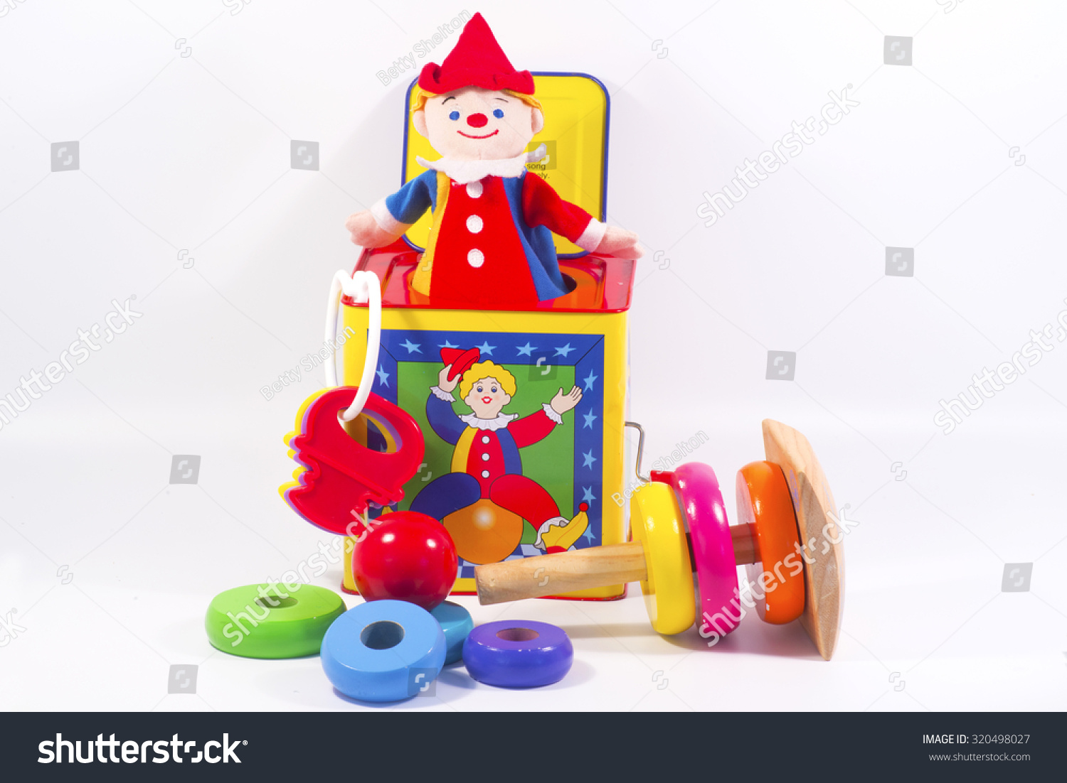 Jack-in-the-box toy and round wooden painted o-rings to stack for kids. #320498027