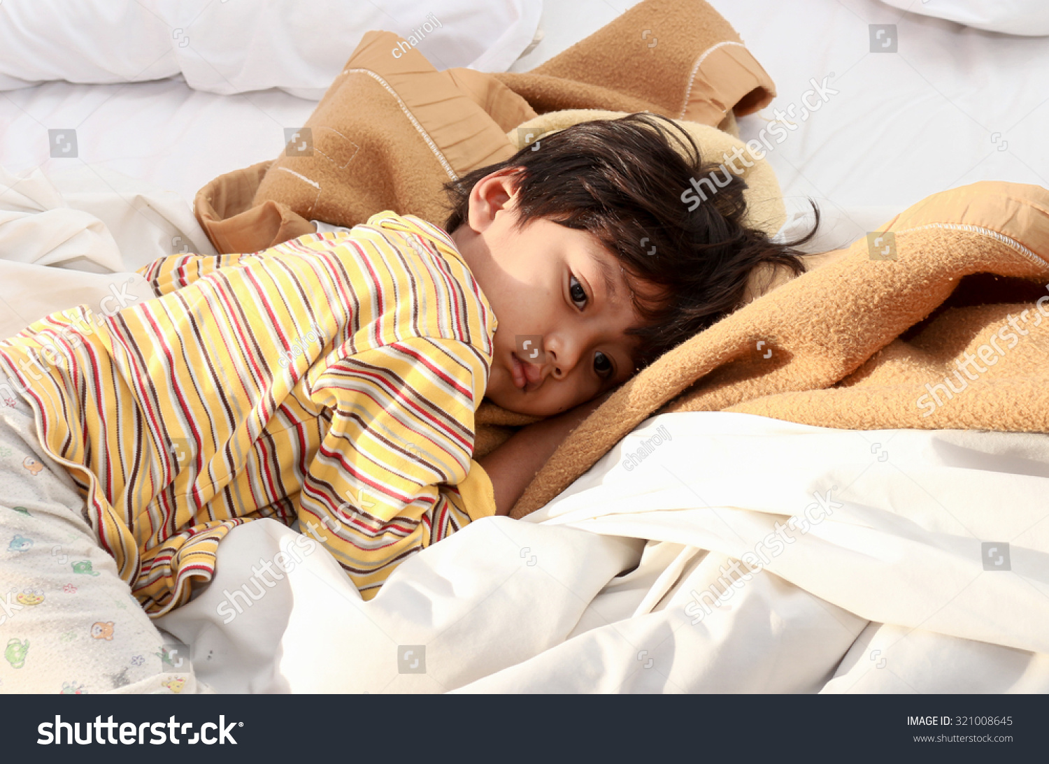 Little boy sleeping on bed in morning sun Shines. #321008645
